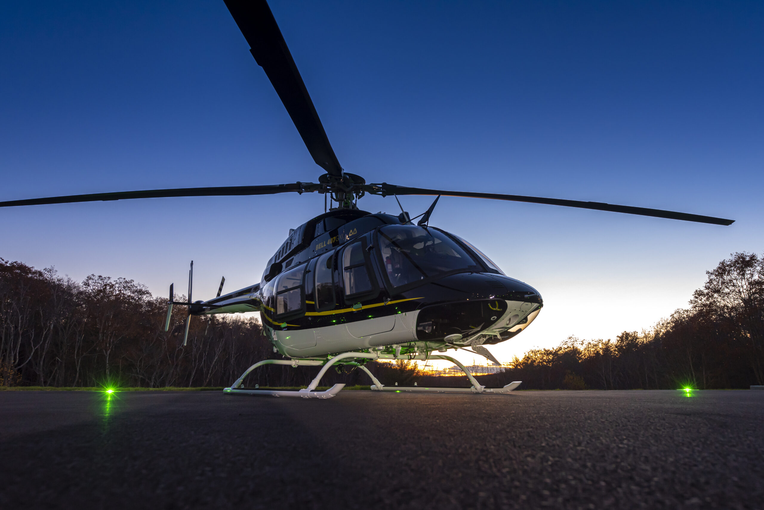 GPMS next-gen HUMS Customer Profile, Municipal Group's Bell 407GXi on tarmac at sunset.